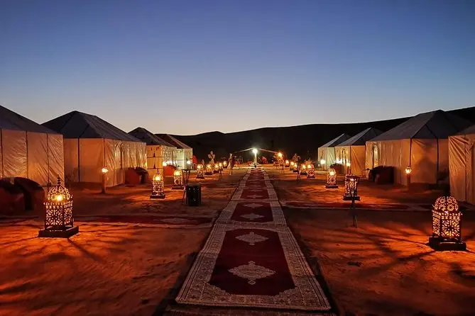 Camel caravan crossing Sahara dunes on the Fes to Marrakech 3-day private tour